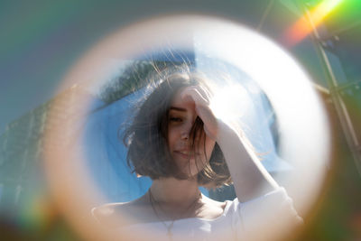 Close-up portrait of woman seen through circle shape