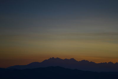 Scenic view of silhouette mountain against sky during sunset