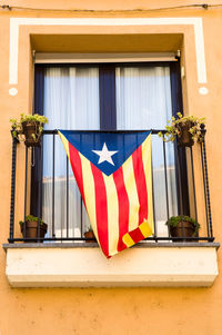 Low angle view of flag against building