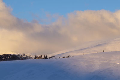 Scenic view of snow covered land against sky