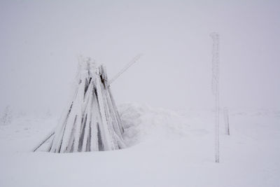 Frozen landscape against sky