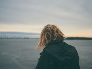 Rear view of woman looking at sea against sky