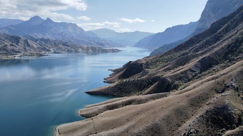 Scenic view of lake and mountains against sky