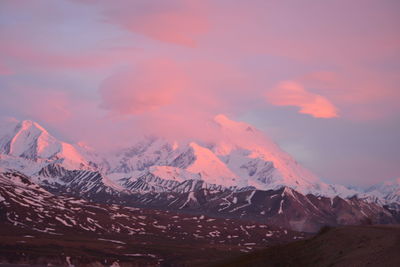 Scenic view of snowcapped mountains against sky during sunset