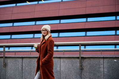 Woman at city street with coffee cup