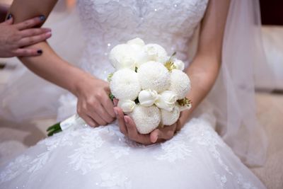 Midsection of woman holding bouquet