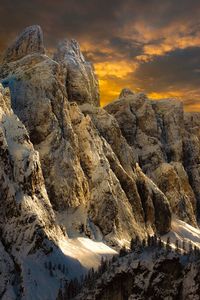 Scenic view of snowcapped mountains against sky during sunset