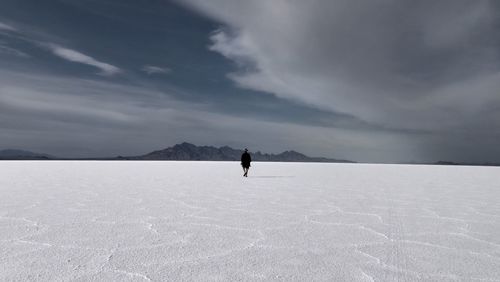 Rear view of person walking on bonneville salt flats