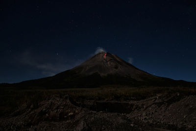 Scenic view of landscape against sky at night