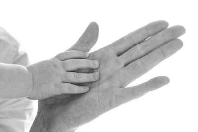 Cropped hand gesturing against white background