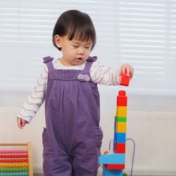 Baby girl playing with toy blocks