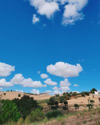 Scenic view of landscape against blue sky