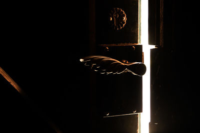 Man hand on illuminated window at night