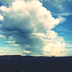 Scenic view of landscape against cloudy sky