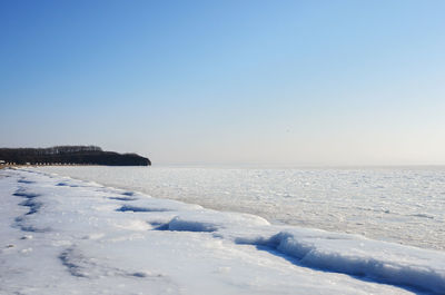 Scenic view of sea against clear sky during winter