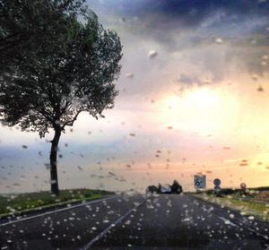 Road seen through wet car windshield