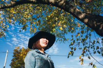 Portrait of smiling young woman with autumn leaves