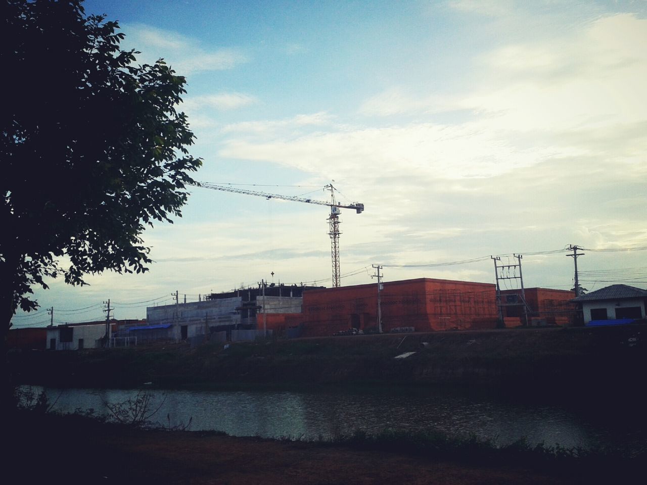 SILHOUETTE OF BUILDINGS AND CRANE