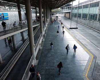 High angle view of people walking at railroad station