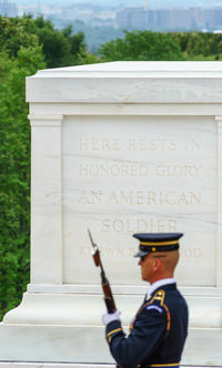 Man standing by text on wall