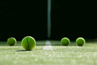 Close-up of tennis balls on field in court