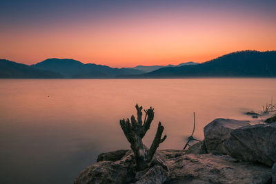 Scenic view of lake against sky during sunset