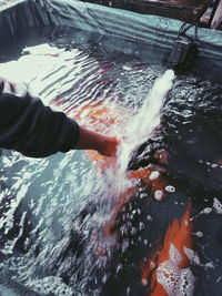 Person splashing water in sea