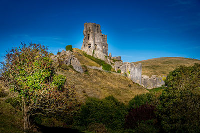 Low angle view of fort against blue sky