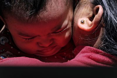 Close-up of boy and grandmother embracing