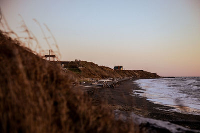 Scenic view of sea against clear sky during sunset