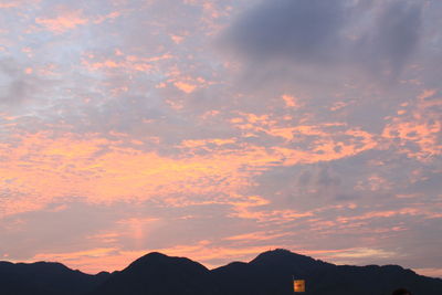 Low angle view of silhouette mountains against romantic sky