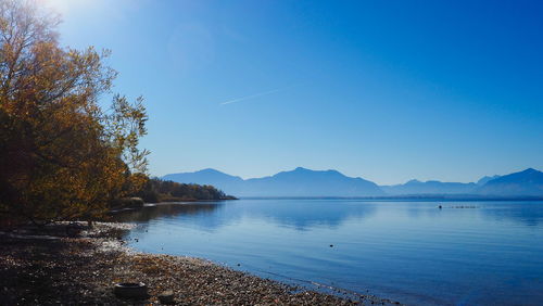 Scenic view of lake against clear blue sky