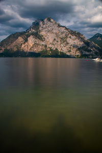 Scenic view of sea and mountains against sky