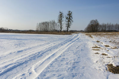 Snow covered field against sky