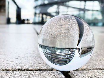 Close-up of crystal ball on glass