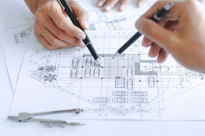 Close-up of architects making blueprint