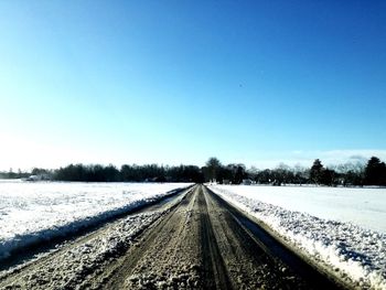 Snow covered landscape against sky