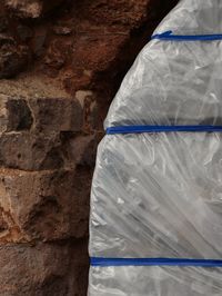 Polythene wrapped by stone wall