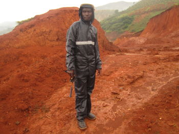 Portrait of young man standing on rock