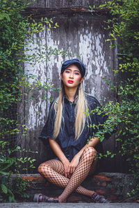 Portrait of a young woman sitting outdoors