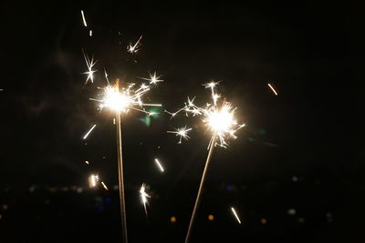 Low angle view of firework display at night