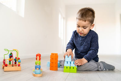 Boy playing with toy at home