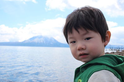 Portrait of boy by sea at hokkaido