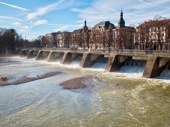 View of dam by river against sky