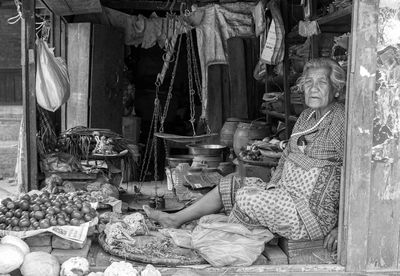 Portrait of senior woman selling vegetables at market stall