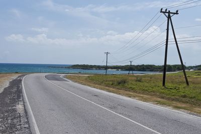 Road by sea against sky