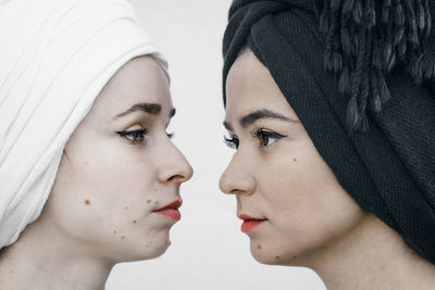 Close-up of women with headscarves against white background