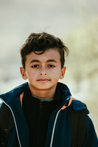 Portrait of boy standing outdoors