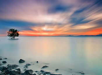 Scenic view of sea against sky at sunset