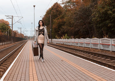 Portrait of woman on railroad station platform